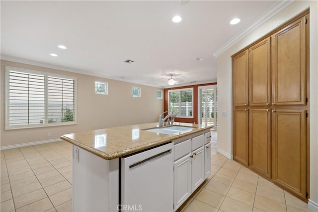 kitchen with crown molding, white dishwasher, a center island with sink, and white cabinets