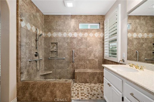 bathroom with a stall shower and vanity