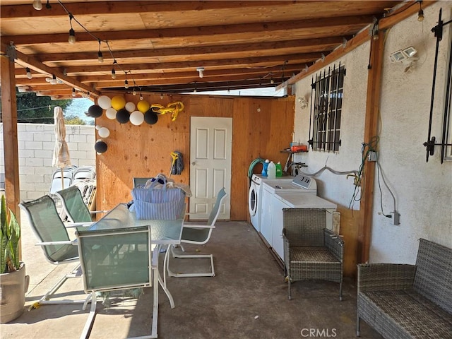 view of patio / terrace with outdoor dining area and separate washer and dryer