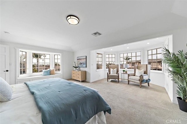 bedroom featuring light colored carpet, visible vents, baseboards, and multiple windows