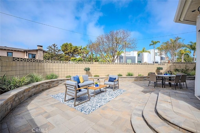 view of patio / terrace featuring outdoor dining area, outdoor lounge area, and a fenced backyard