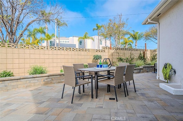 view of patio / terrace featuring outdoor dining space and a fenced backyard