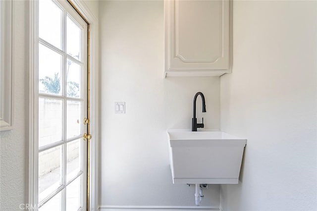 clothes washing area with a sink