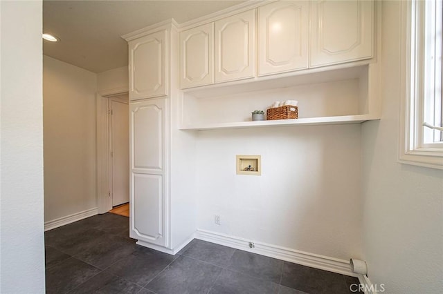 clothes washing area with hookup for a washing machine and baseboards