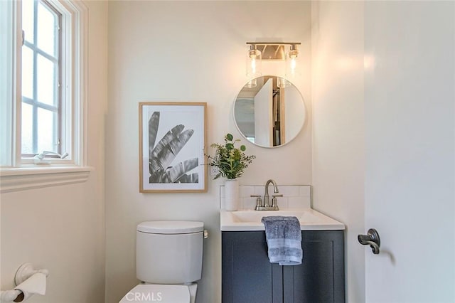 half bathroom featuring toilet and vanity