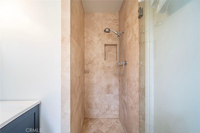 bathroom with a shower stall and vanity