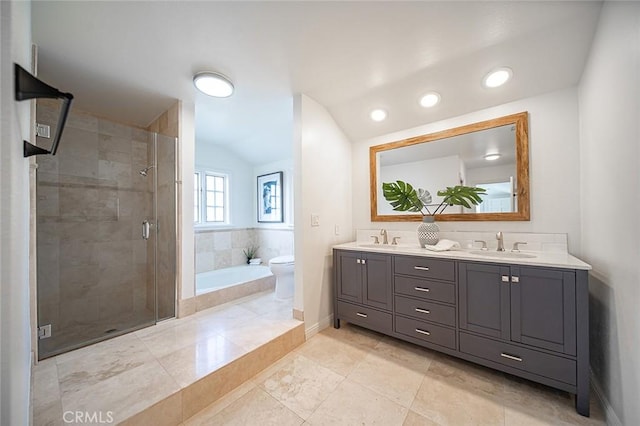 bathroom with vaulted ceiling, a sink, a bath, and a shower stall