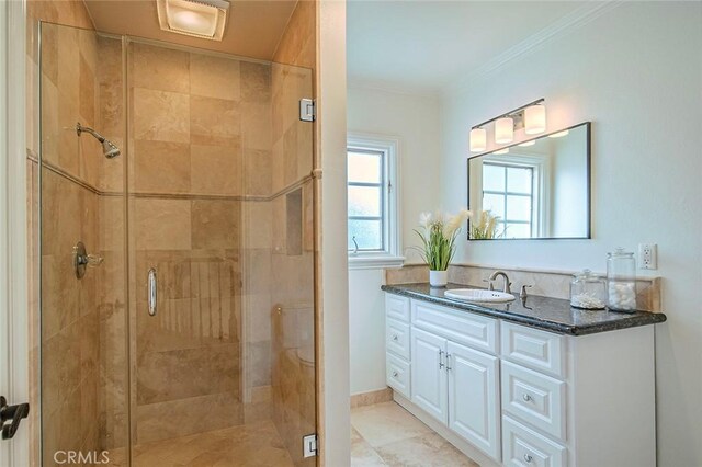 full bath with a stall shower, vanity, and crown molding