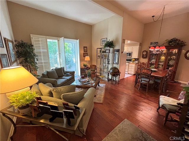 living room featuring a high ceiling and dark wood-type flooring