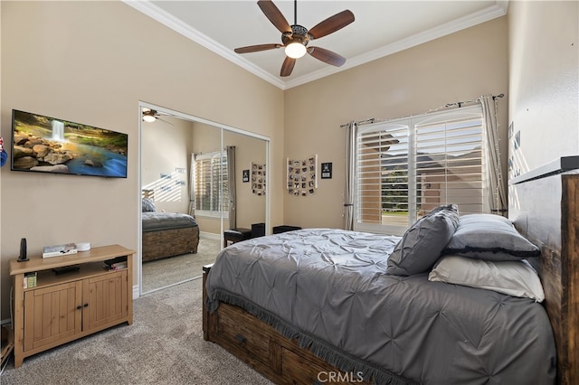 bedroom featuring a ceiling fan, a closet, light carpet, and crown molding