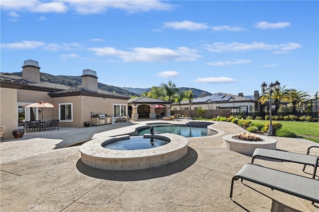 view of pool featuring a fenced in pool, an in ground hot tub, fence, a gazebo, and a mountain view