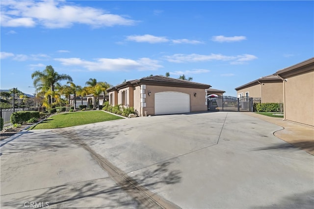 view of side of home featuring stucco siding, a gate, a garage, a residential view, and driveway