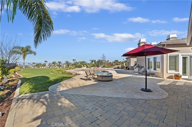 view of patio / terrace with an outdoor fire pit