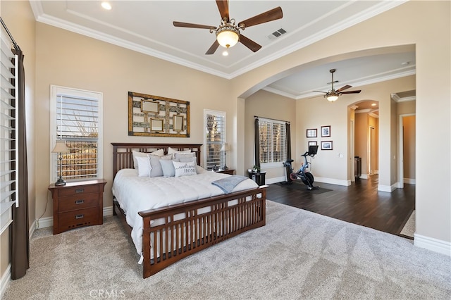 bedroom with baseboards, visible vents, arched walkways, and ornamental molding