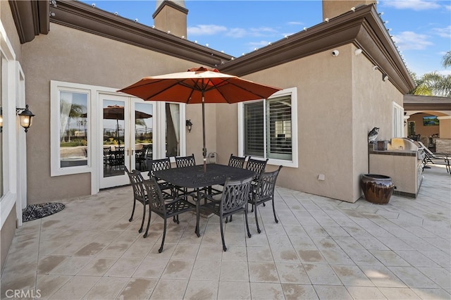 view of patio / terrace with exterior kitchen and outdoor dining space