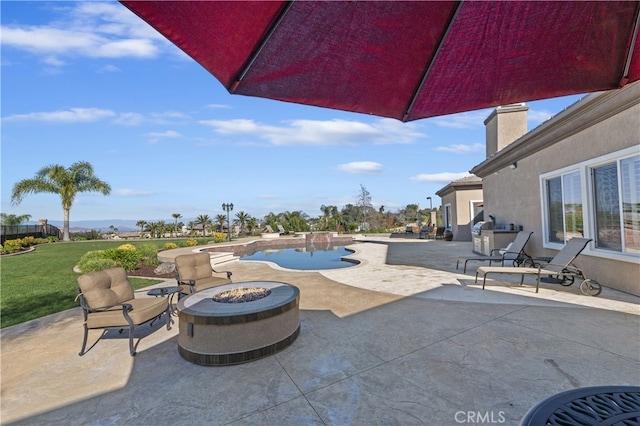 view of patio with a fire pit