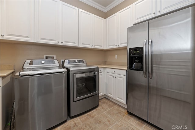 washroom featuring ornamental molding and washing machine and clothes dryer