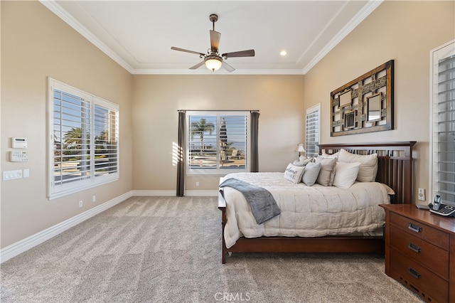 bedroom with light colored carpet, crown molding, baseboards, and ceiling fan