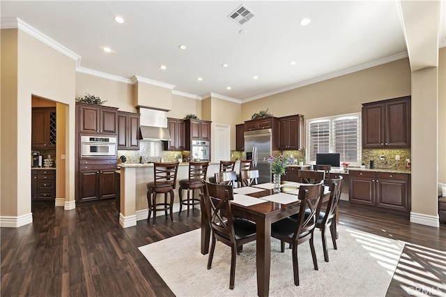 dining area with baseboards, visible vents, ornamental molding, dark wood-style flooring, and a high ceiling