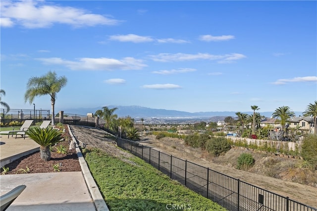 view of home's community with fence and a mountain view