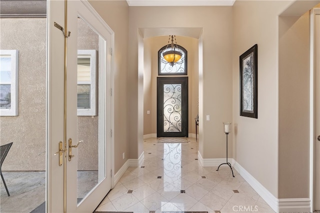 entryway with french doors and baseboards