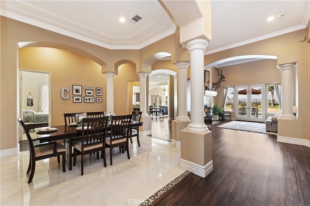 dining area featuring ornamental molding, french doors, visible vents, and ornate columns