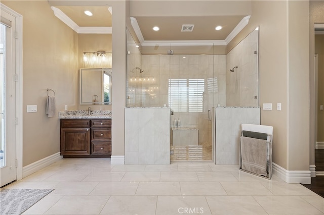 bathroom with a shower stall, baseboards, crown molding, and vanity