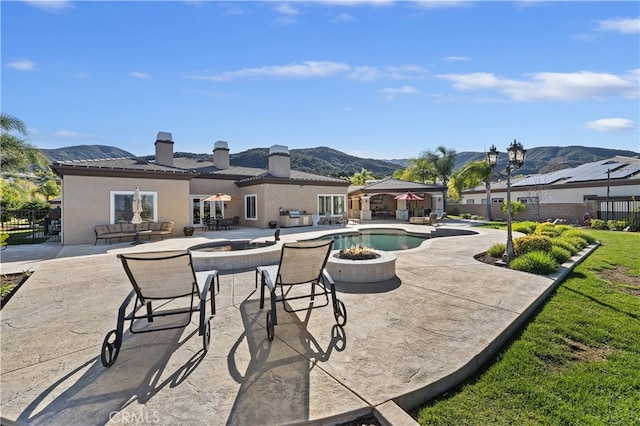 view of pool with a fenced in pool, a mountain view, and fence