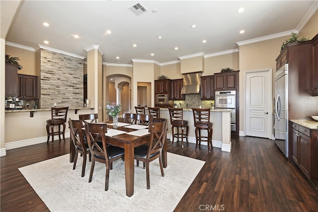 dining area with arched walkways, dark wood-style flooring, visible vents, and crown molding