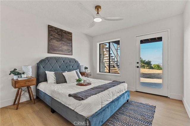 bedroom featuring access to exterior, light wood-style flooring, baseboards, and a ceiling fan