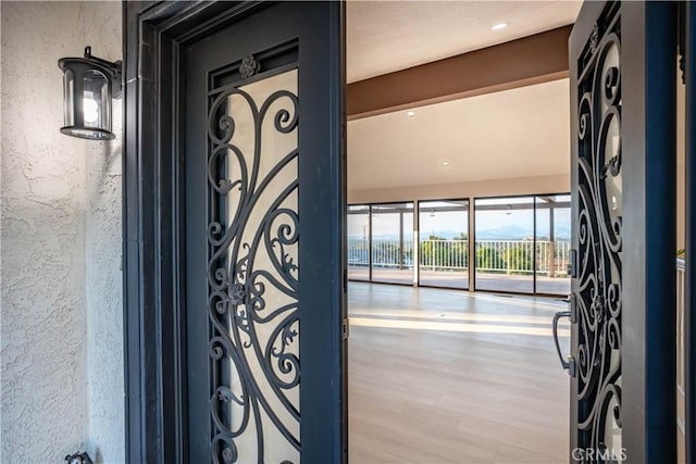 details with a textured wall and wood finished floors