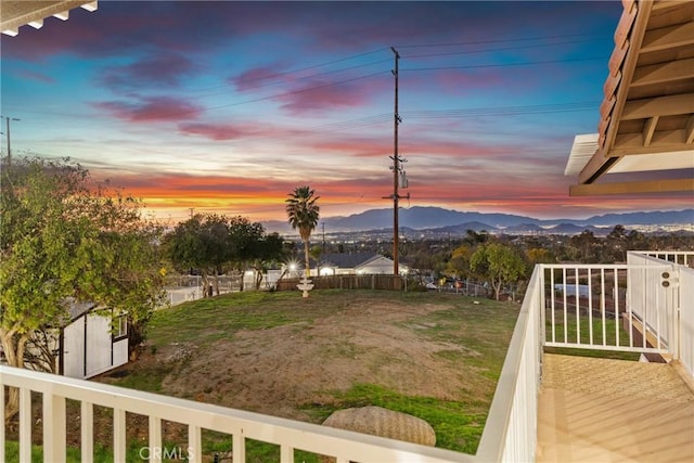 view of yard with a storage shed, an outbuilding, a balcony, and a mountain view