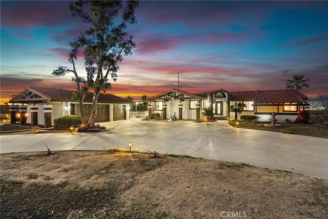 view of front facade with an attached garage, concrete driveway, and stucco siding