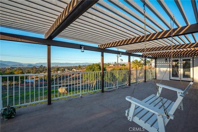 view of patio / terrace with fence, a mountain view, and a pergola