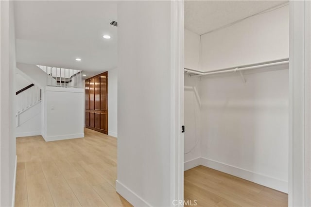 walk in closet with light wood-style floors and visible vents