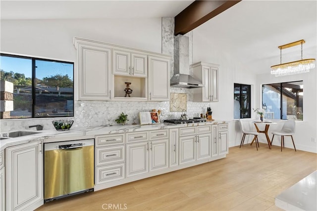 kitchen featuring stainless steel appliances, light wood-style floors, decorative backsplash, wall chimney exhaust hood, and decorative light fixtures