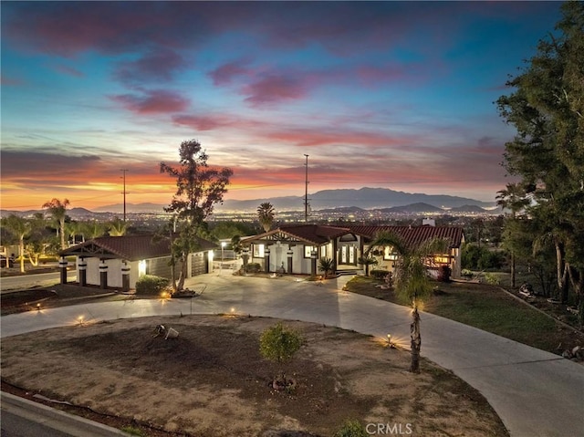 view of front of house featuring a mountain view and driveway