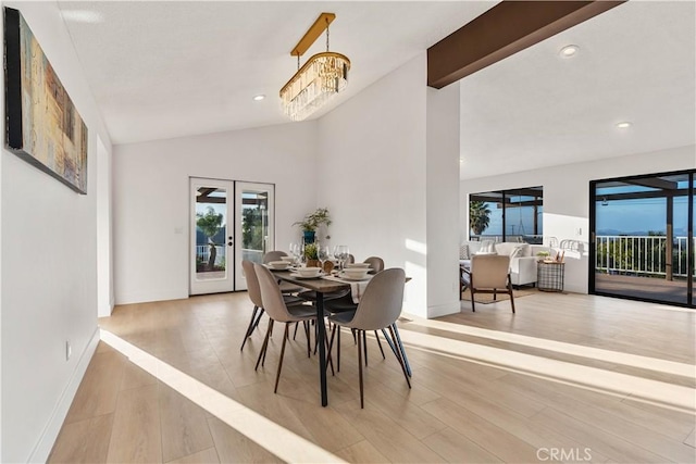 dining space featuring vaulted ceiling with beams, a chandelier, light wood-style flooring, recessed lighting, and french doors