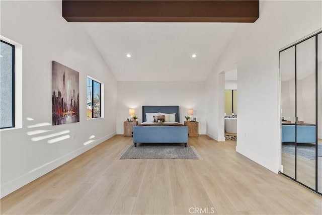 bedroom with light wood-type flooring, beam ceiling, and baseboards