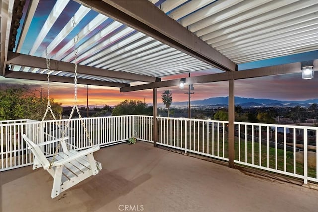 patio terrace at dusk featuring a mountain view