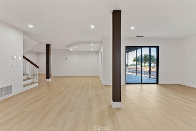 spare room featuring stairs, light wood-style flooring, visible vents, and recessed lighting