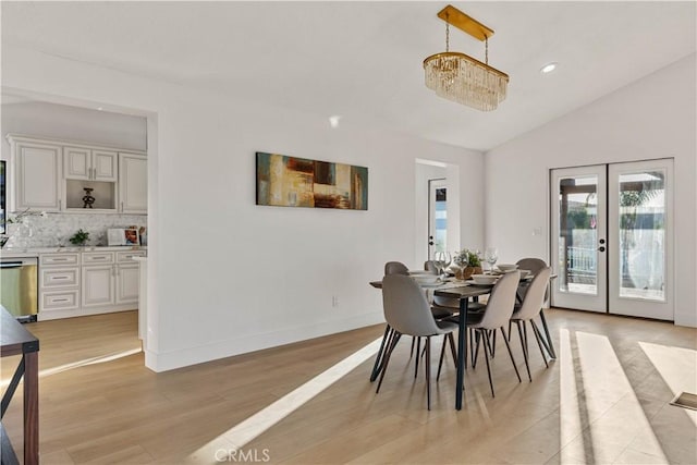 dining room with recessed lighting, baseboards, vaulted ceiling, french doors, and light wood finished floors