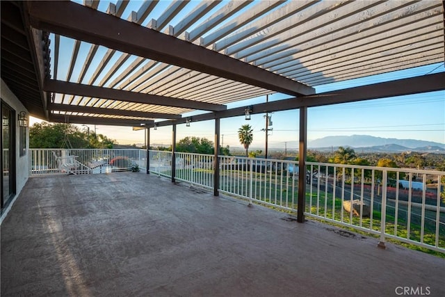 view of patio / terrace featuring a mountain view, fence, and a pergola