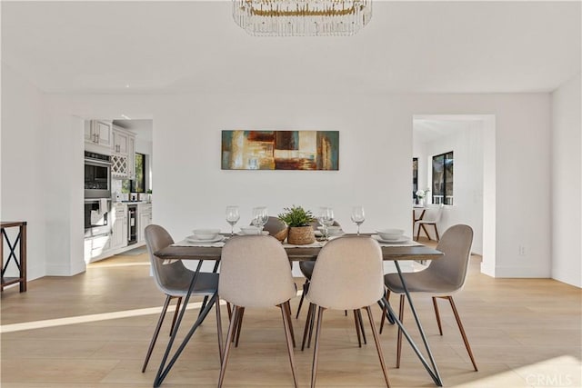 dining room with light wood-style flooring and baseboards