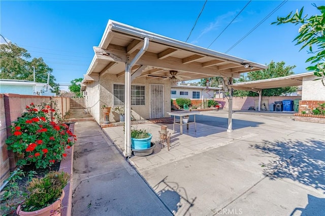 view of patio with ceiling fan and fence