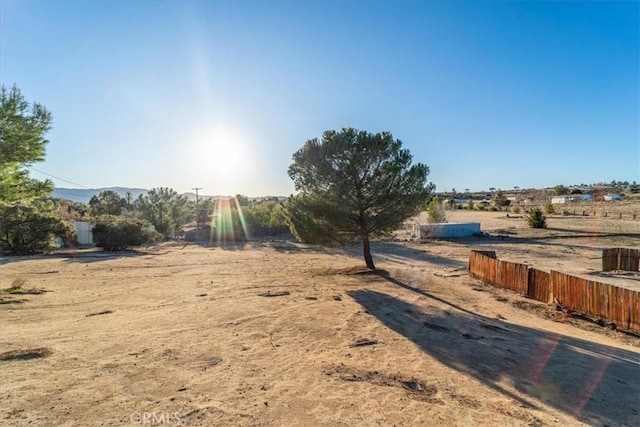 view of yard with a rural view and fence