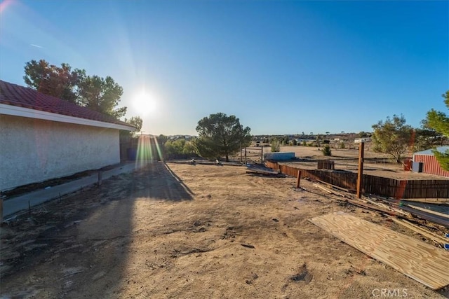 view of yard with a rural view and fence