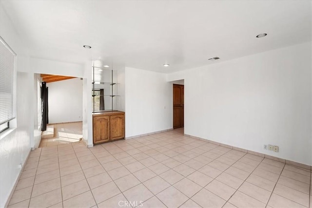 unfurnished room featuring light tile patterned flooring, visible vents, and recessed lighting