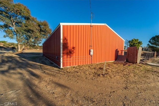 view of pole building with fence