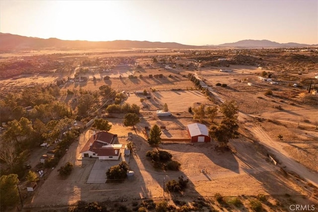 aerial view at dusk featuring a mountain view